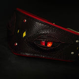 Close-up of the red dragon eye on the Blood Dragon leather dog collar, with snake-embossed dark red leather, red crystals, silver studs and red lining